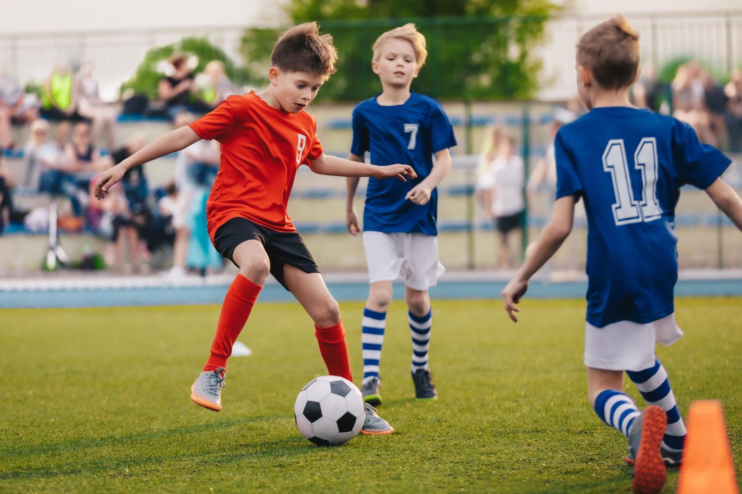 Energetic Boys Playing Soccer Together on a Sunny Field
