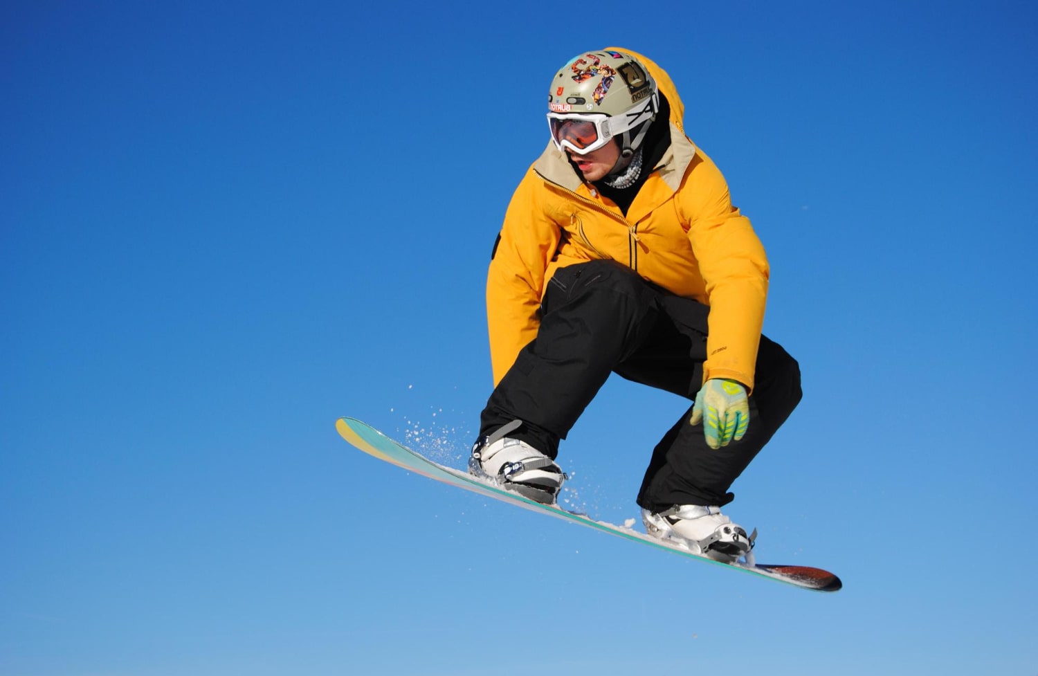 Snowboarder Soaring Through Clouds with Power, Style, and Freedom